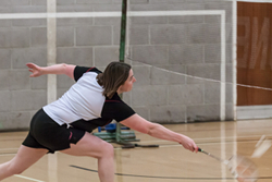 Image of a player playing badminton playing a net shot.